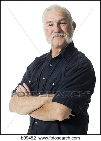 Portrait of an elderly man standing with his arms crossed View Large Photo Image Stock Image - Portrait of an elderly man standing with his arms crossed. Fotosearch