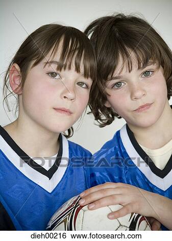 Stock Photograph - Portrait of two girls holding a soccer ball. Fotosearch