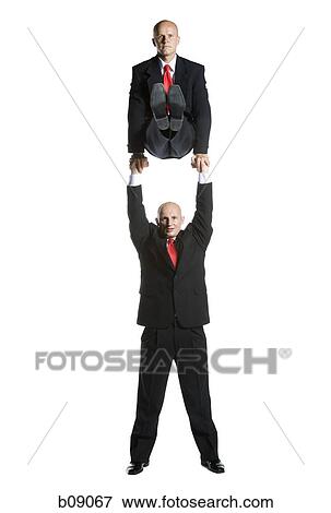Portrait of two male acrobats in business suits performing View Large Photo Image Stock Photo - Portrait of two male acrobats in business suits performing. Fotosearch