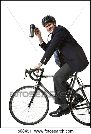Profile of a businessman cycling and holding from a mug View Large Photo Image Stock Image - Profile of a businessman cycling and holding from a mug. Fotosearch