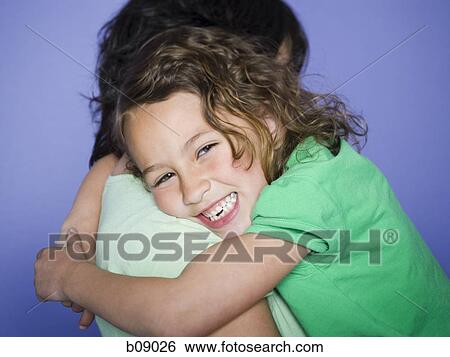 Profile of a girl hugging her mother View Large Photo Image Stock Photograph - Profile of a girl hugging her mother. Fotosearch