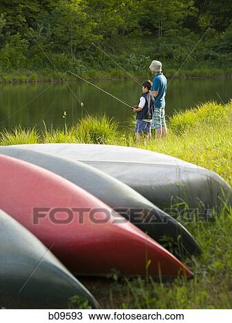 Stock Image - Profile of a man and his son fishing. Fotosearch