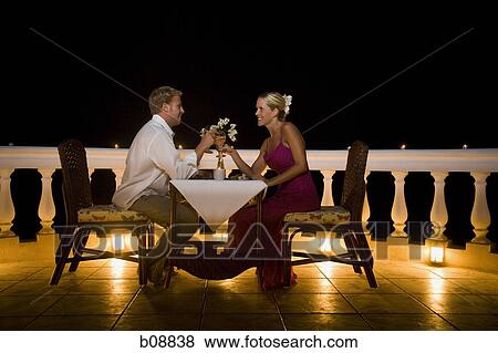 Profile of a man and woman dining on the balcony View Large Photo Image Stock Photo - Profile of a man and woman dining on the balcony. Fotosearch