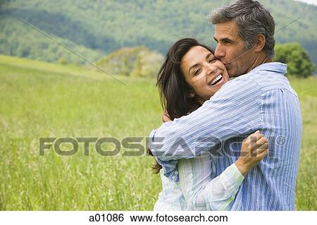 Profile of a mature man kissing a mid adult woman View Large Photo Image Stock Photograph - Profile of a mature man kissing a mid adult woman. Fotosearch