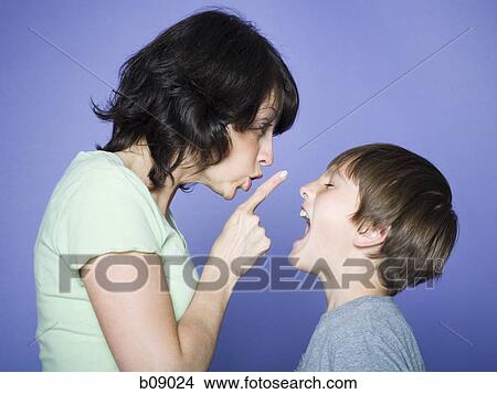 Profile of a mother scolding her son View Large Photo Image Picture - Profile of a mother scolding her son. Fotosearch