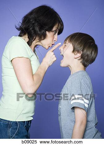 Profile of a mother scolding her son View Large Photo Image Stock Photography - Profile of a mother scolding her son. Fotosearch