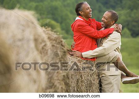Profile of a senior man and a senior woman embracing each other View Large Photo Image Stock Photo - Profile of a senior man and a senior woman embracing each other. Fotosearch