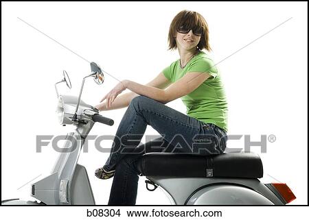 Profile of a teenage girl sitting on a scooter View Large Photo Image Picture - Profile of a teenage girl sitting on a scooter. Fotosearch
