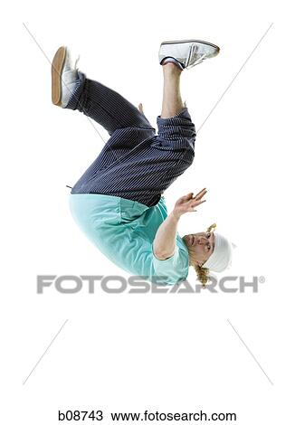 Stock Image - Profile of a young man doing a back flip. Fotosearch