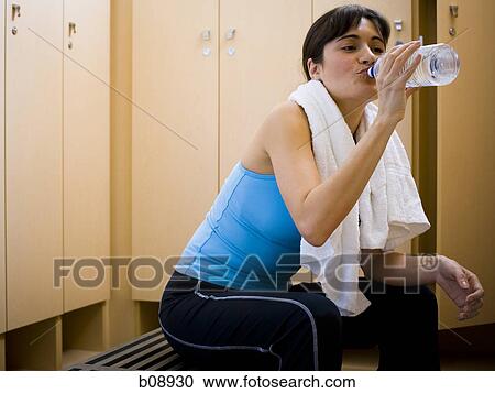 Profile of a young woman drinking water from a water bottle View Large Photo Image Stock Image - Profile of a young woman drinking water from a water bottle. Fotosearch