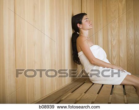 Profile of a young woman relaxing in a sauna View Large Photo Image Stock Photo - Profile of a young woman relaxing in a sauna. Fotosearch