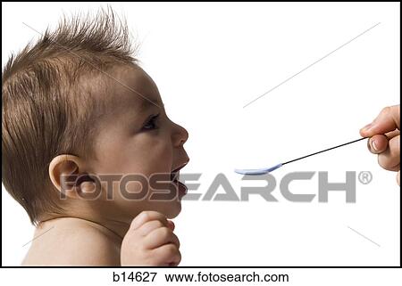 Profile of baby with spoon View Large Photo Image Stock Photo - Profile of baby with spoon. Fotosearch