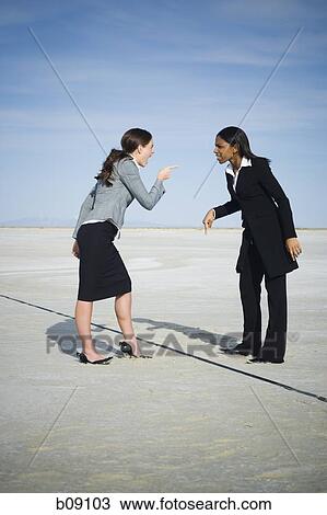 Profile of two businesswomen arguing View Large Photo Image Stock Image - Profile of two businesswomen arguing. Fotosearch