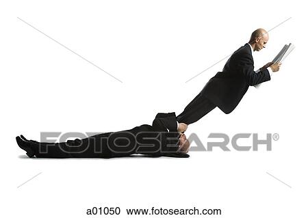Stock Image - Profile of two male acrobats in business suits. Fotosearch