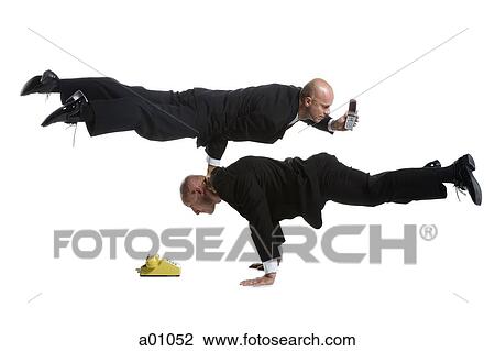 Profile of two male acrobats in business suits performing View Large Photo Image Stock Image - Profile of two male acrobats in business suits performing. Fotosearch