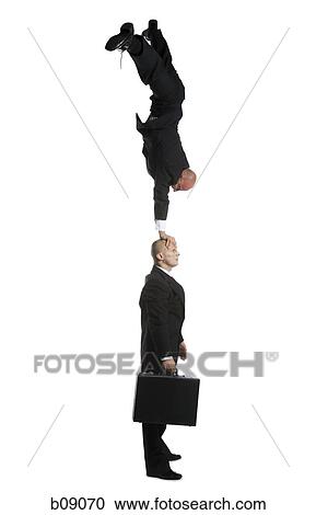 Profile of two male acrobats in business suits performing View Large Photo Image Stock Image - Profile of two male acrobats in business suits performing. Fotosearch