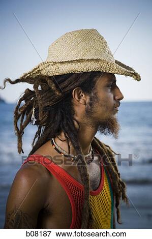 Rastafarian wearing a straw hat View Large Photo Image Stock Photo - Rastafarian wearing a straw hat. Fotosearch