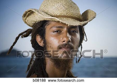 Rastafarian wearing a straw hat View Large Photo Image Stock Photo - Rastafarian wearing a straw hat. Fotosearch