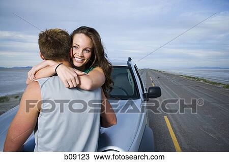 Rear view of a mid adult man and a young woman embracing each other View Large Photo Image Stock Image - Rear view of a mid adult man and a young woman embracing each other. Fotosearch