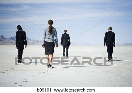Rear view of two businessmen and two businesswomen walking together View Large Photo Image Stock Image - Rear view of two businessmen and two businesswomen walking together. Fotosearch