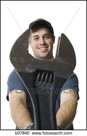 Repairman holding a wrench View Large Photo Image Stock Image - Repairman holding a wrench. Fotosearch