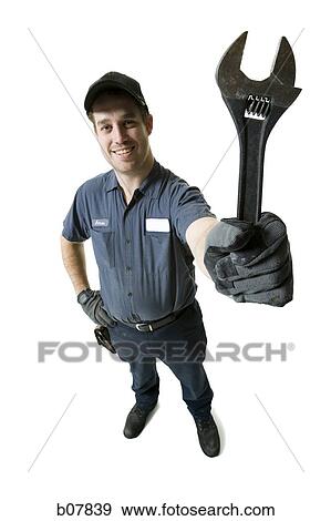Repairman holding a wrench View Large Photo Image Stock Photo - Repairman holding a wrench. Fotosearch