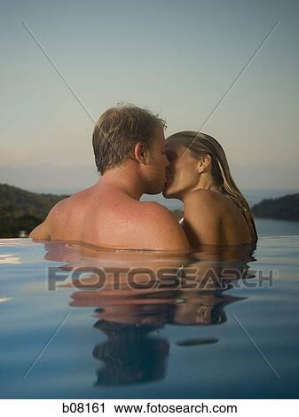 Romantic couple in infinity pool View Large Photo Image Stock Image - Romantic couple in infinity pool. Fotosearch