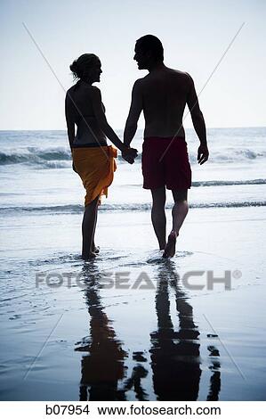 Romantic couple strolling on the beach View Large Photo Image Picture - Romantic couple strolling on the beach. Fotosearch