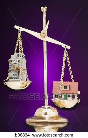 Scale balancing house and roll of banknotes View Large Photo Image Picture - Scale balancing house and roll of banknotes. Fotosearch