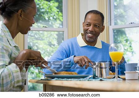 Senior man and a senior woman having breakfast View Large Photo Image Stock Photograph - Senior man and a senior woman having breakfast. Fotosearch