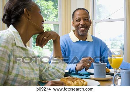 Senior man and a senior woman sitting at the breakfast table View Large Photo Image Picture - Senior man and a senior woman sitting at the breakfast table. Fotosearch