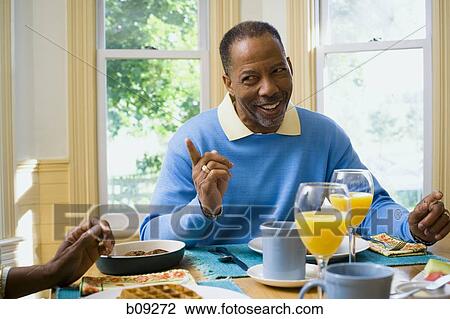 Senior man sitting at the breakfast table View Large Photo Image Stock Image - Senior man sitting at the breakfast table. Fotosearch