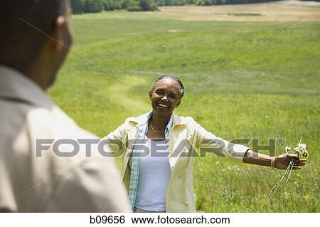 Senior woman smiling in front of a senior man View Large Photo Image Stock Photograph - Senior woman smiling in front of a senior man. Fotosearch