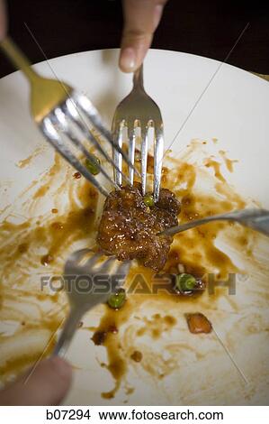 Several Forks grabbing for last meatball in plate View Large Photo Image Picture - Several Forks grabbing for last meatball in plate. Fotosearch