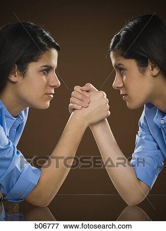 Sisters arm wrestling View Large Photo Image Stock Photo - Sisters arm wrestling. Fotosearch