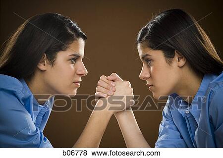 Sisters arm wrestling View Large Photo Image Stock Photo - Sisters arm wrestling. Fotosearch