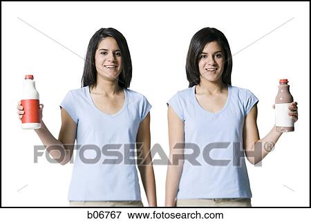Sisters holding different beverages View Large Photo Image Stock Photo - Sisters holding different beverages. Fotosearch