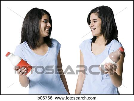 Sisters holding different beverages View Large Photo Image Stock Photograph - Sisters holding different beverages. Fotosearch