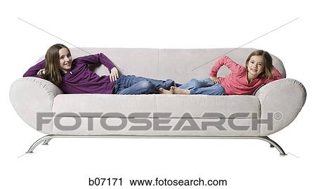 Sisters posing on couch View Large Photo Image Stock Image - Sisters posing on couch. Fotosearch