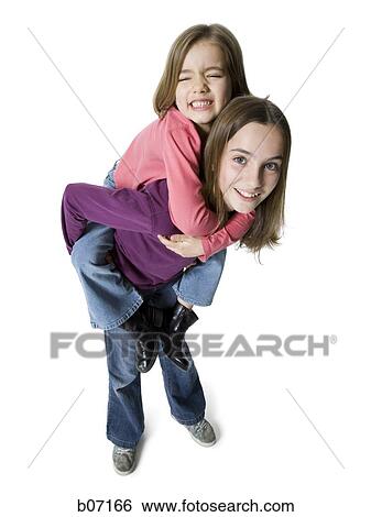 Sisters posing piggy back View Large Photo Image Stock Photograph - Sisters posing piggy back. Fotosearch
