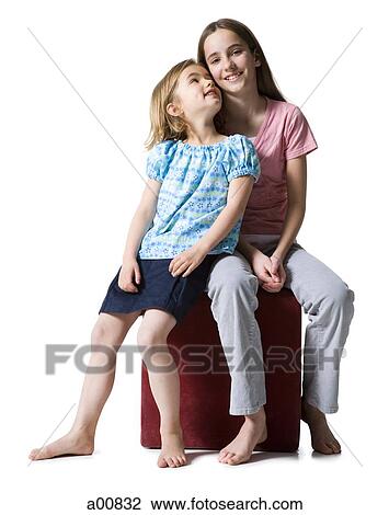 Sisters sitting and smiling View Large Photo Image Stock Image - Sisters sitting and smiling. Fotosearch