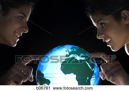Sisters studying earth globe View Large Photo Image Stock Image - Sisters studying earth globe. Fotosearch