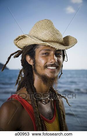Smiling Rastafarian male in straw hat View Large Photo Image Stock Image - Smiling Rastafarian male in straw hat. Fotosearch