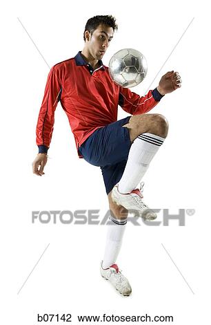 Soccer player bouncing ball on thigh View Large Photo Image Stock Image - Soccer player bouncing ball on thigh. Fotosearch