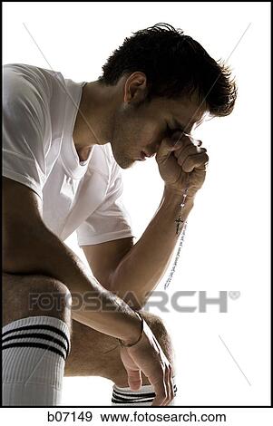 Soccer player praying View Large Photo Image Stock Photo - Soccer player praying. Fotosearch