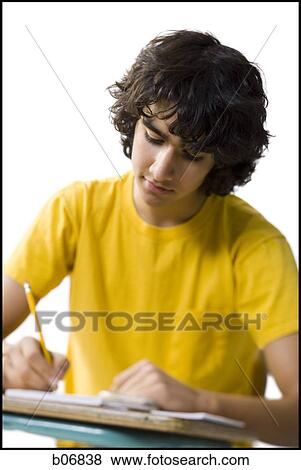 Stock Photo - Student working at school desk. Fotosearch