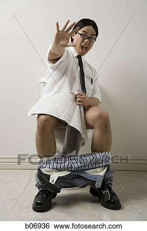 Surprised office worker on toilet with newspaper View Large Photo Image Stock Photograph - Surprised office worker on toilet with newspaper. Fotosearch