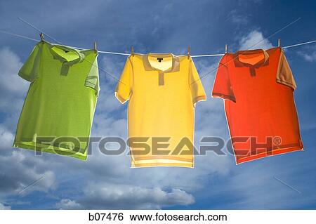 T-shirts hanging on a clothesline View Large Photo Image Stock Photograph - T-shirts hanging on a clothesline. Fotosearch