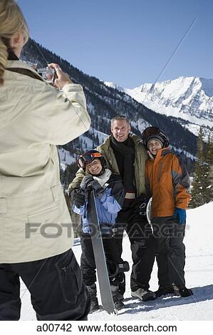 Taking a picture of a family on a snowy mountain View Large Photo Image Stock Image - Taking a picture of a family on a snowy mountain. Fotosearch