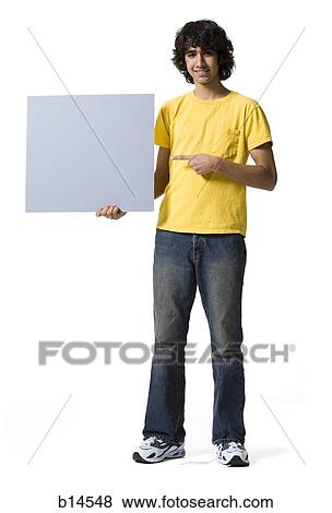 Teenage boy holding blank sign View Large Photo Image Stock Photo - Teenage boy holding blank sign. Fotosearch